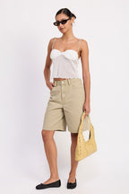 Emory Park sheer mesh floral cami top in white on model with beige bermuda shorts and yellow handbag