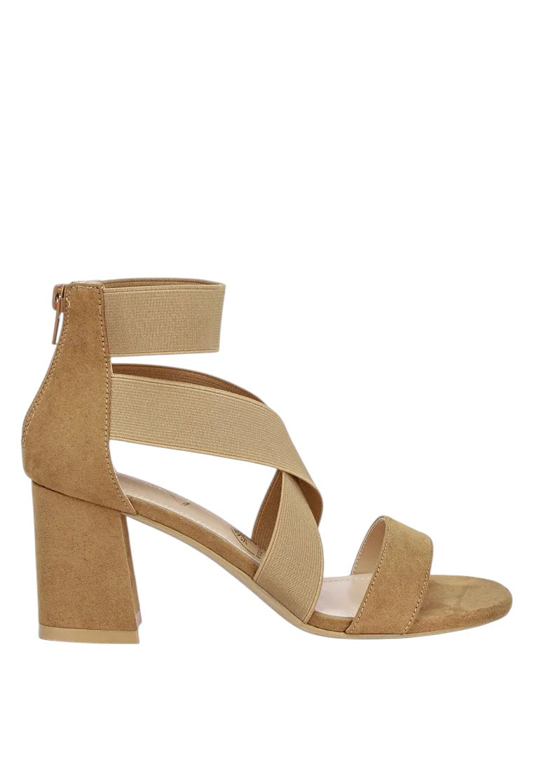 Tan high-heeled sandal on a white background