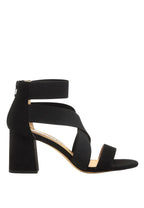 Black strappy sandal with a block heel on a white background