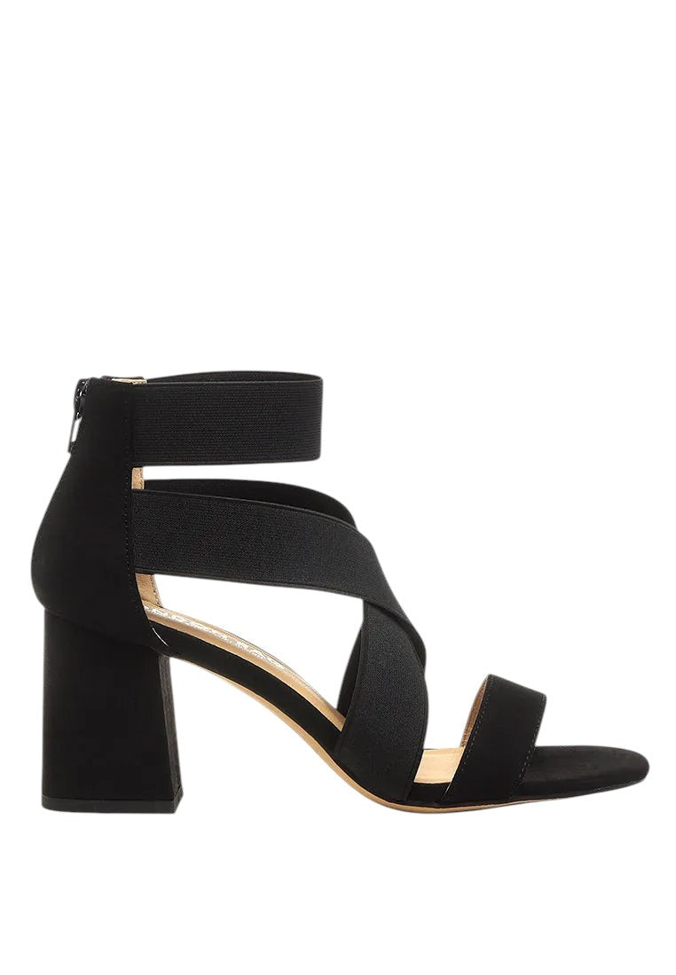 Black strappy sandal with a block heel on a white background