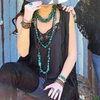 Black African turquoise bead bracelet worn with layered necklaces for a stylish boho look