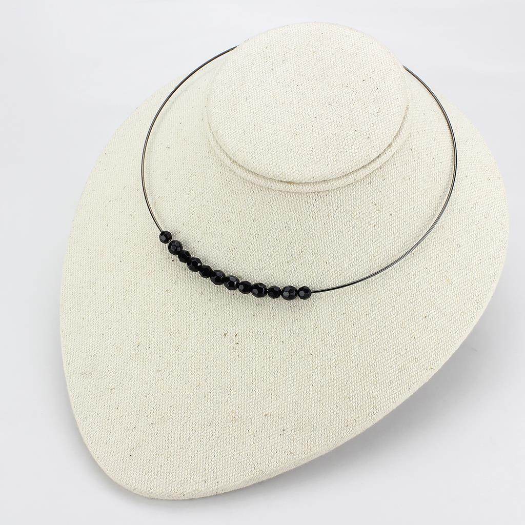 Black beaded minimalist necklace on display with a sleek wire design for elegant style