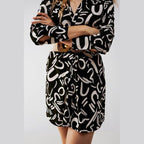Stylish black button front shirt dress featuring a modern abstract pattern and a belted waist