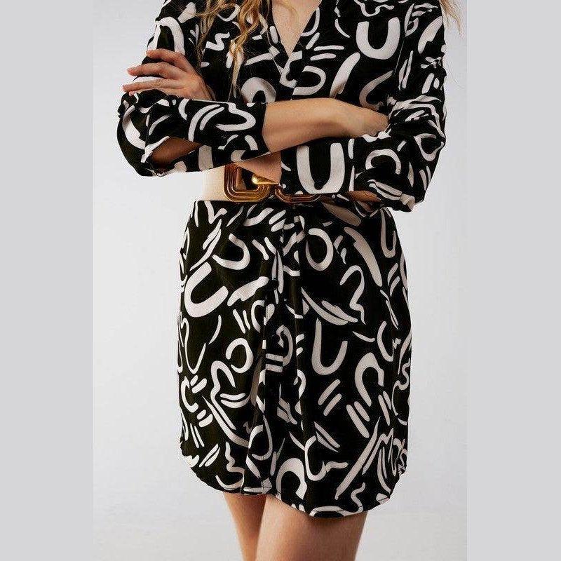 Stylish black button front shirt dress featuring a modern abstract pattern and a belted waist