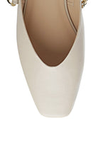Close-up of white Rag Company black chain detail mules showing square toe design