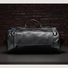 Stylish black coffee leather duffel bag with spacious interior and sturdy handles for travel