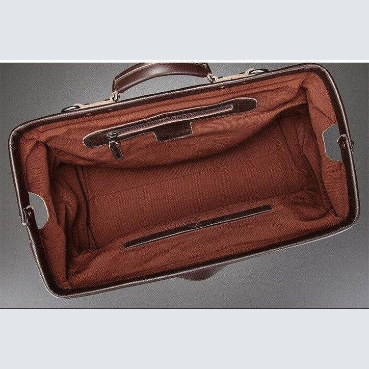 Inside view of black coffee leather duffel featuring spacious brown interior and multiple pockets