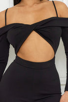 Stylish black cutout jumpsuit for women featuring an off-shoulder design and slim fit.