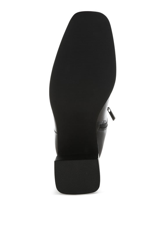 Sole view of Rag Company black faux leather ankle boots with a stylish design and sturdy grip