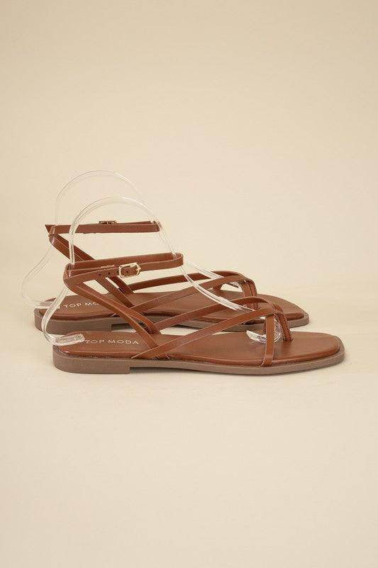 Stylish brown flat strappy sandals from Top Guy Footwear for summer outfits, featuring a sleek design.
