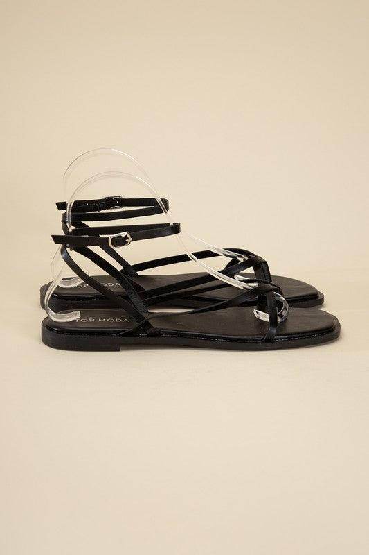 Black flat strappy sandals by Top Guy Footwear with stylish straps for summer outings
