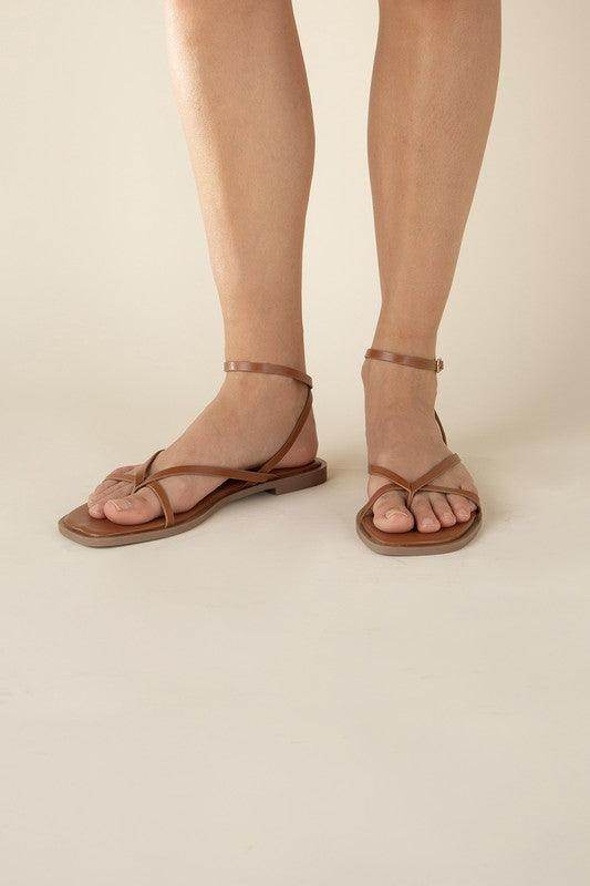 Women wearing Top Guy Footwear black flat strappy sandals for casual summer outings