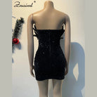 Back view of a black sequin feather mini dress on a mannequin showcasing the strapless fitted design