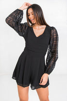Women's black solid short romper with stylish sheer puff sleeves for a chic summer look