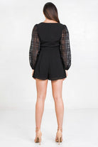Stylish black solid short romper with sheer puff sleeves for a chic summer look