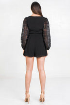 Stylish black solid short romper with sheer puff sleeves for a chic summer look
