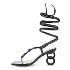 Rag Company black strappy vacation sandals with unique spiral ankle straps and geometric heel design