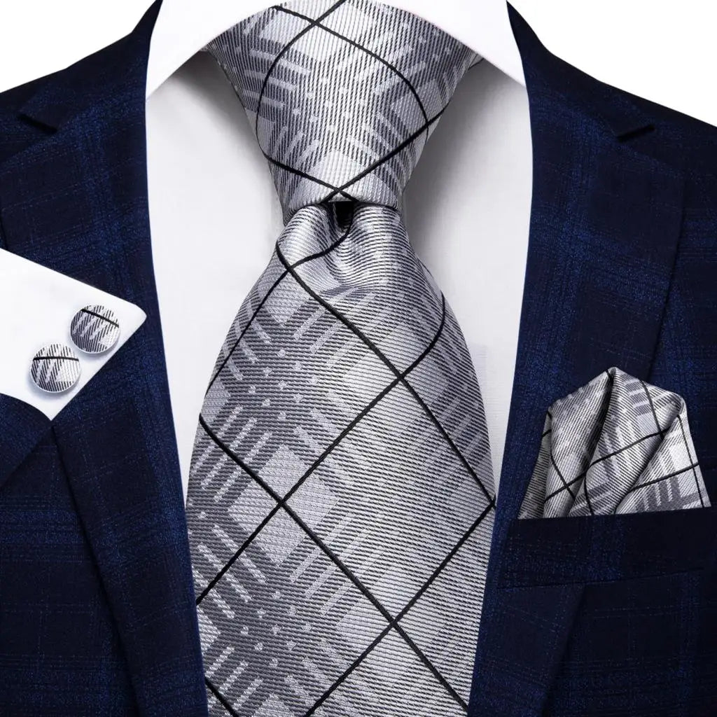 Men's navy blue suit with a silver patterned tie, perfect for black tie wedding guest dress