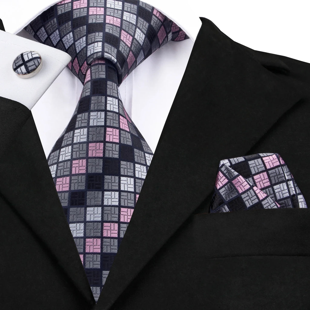 Men's black tie wedding guest dress with patterned tie and pocket square