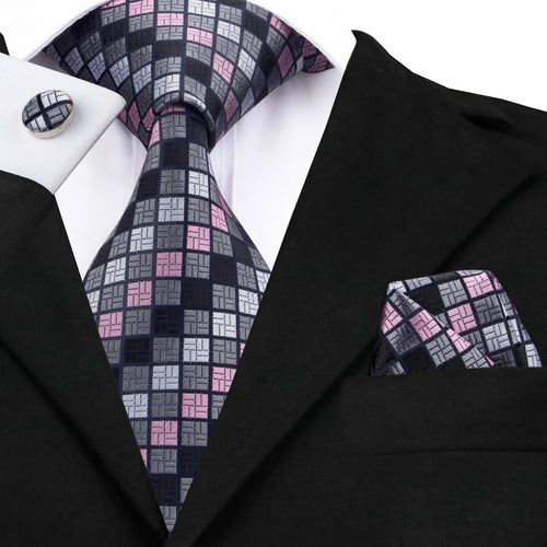 Men's black tie wedding guest dress with patterned tie and pocket square