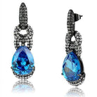 Sparkling blue crystal drop earrings with intricate black embellishments for a stylish look