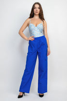 VacationGrabs women's high-rise cargo parachute pants in vibrant blue worn with a floral top