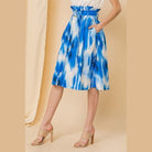 VacationGrabs blue midi vacation skirt with white pattern and paperbag waist worn with beige heels