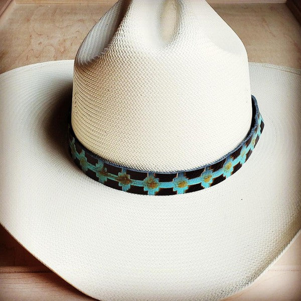 White cowboy hat adorned with a striking blue Navajo leather hat band for a stylish touch