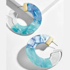 ClaudiaG Collection blue resin hoop earrings with a stunning marbled design and gold accents