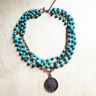 Blue turquoise coin necklace featuring multiple strands and a vintage coin pendant