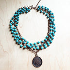 Blue turquoise coin necklace featuring multiple strands and a vintage coin pendant
