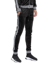 Black velour jogger pants with white geometric side stripes and cuffs by WEIV