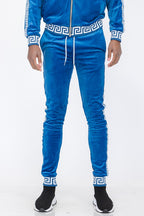 WEIV blue velour jogger pants with white Greek key pattern on waistband and cuffs