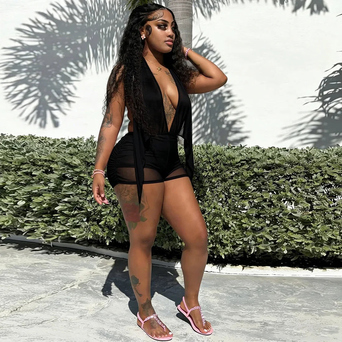 Women's black vacation outfit with bodycon dress style, perfect for warm weather