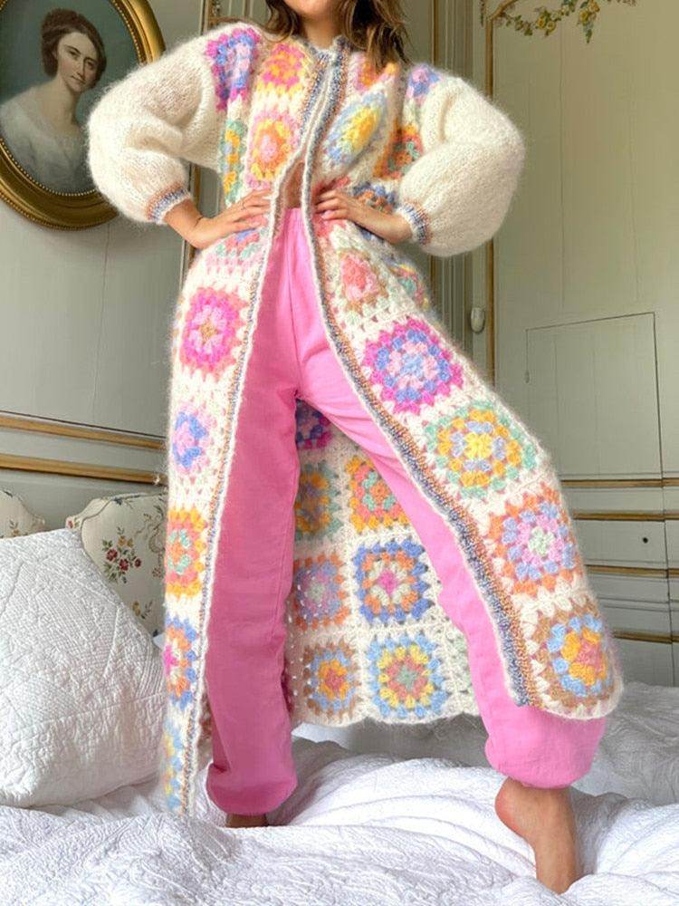 Women's bohemian style sweater with colorful granny square patterns, designed for a cozy look