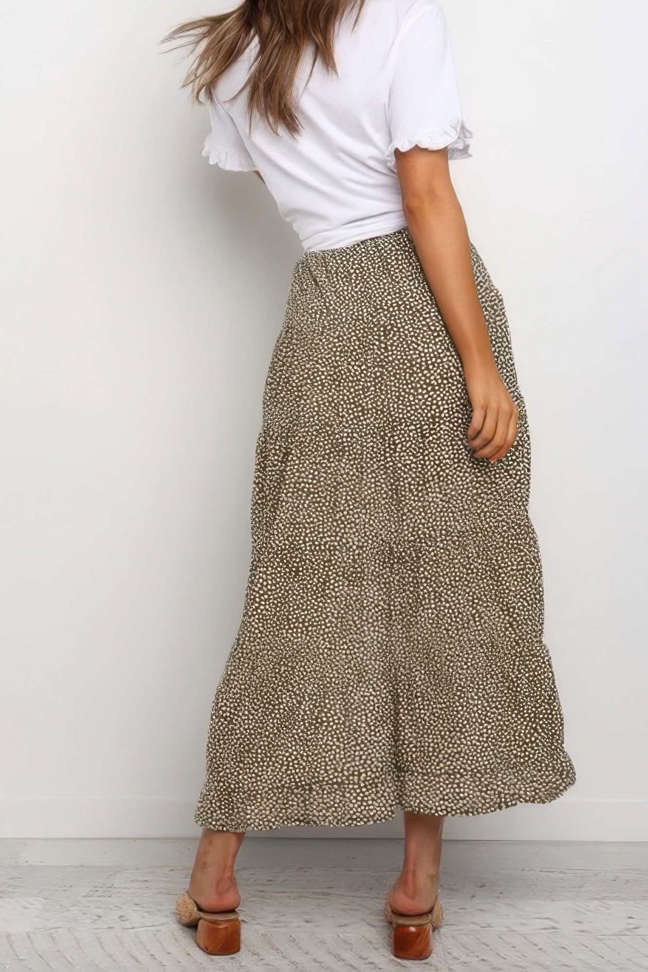 VacationGrabs boho floral midi skirt worn by woman with white top and sandals from back view