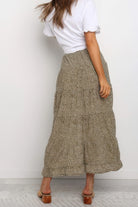 VacationGrabs boho floral midi skirt worn by woman with white top and sandals from back view