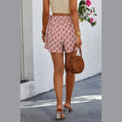 VacationGrabs boho fringe shorts for women with red and white pattern worn outdoors