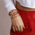 Stylish boho gold charm bracelets stacked on a woman's wrist, perfect for adding a trendy touch