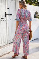 Back view of a colorful boho print jumpsuit for women, featuring flowy sleeves and a relaxed fit