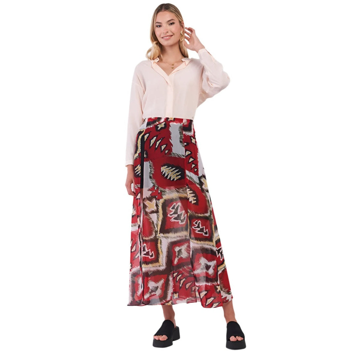 Boho vacation skirt for women with red and beige abstract patterns worn with a light blouse