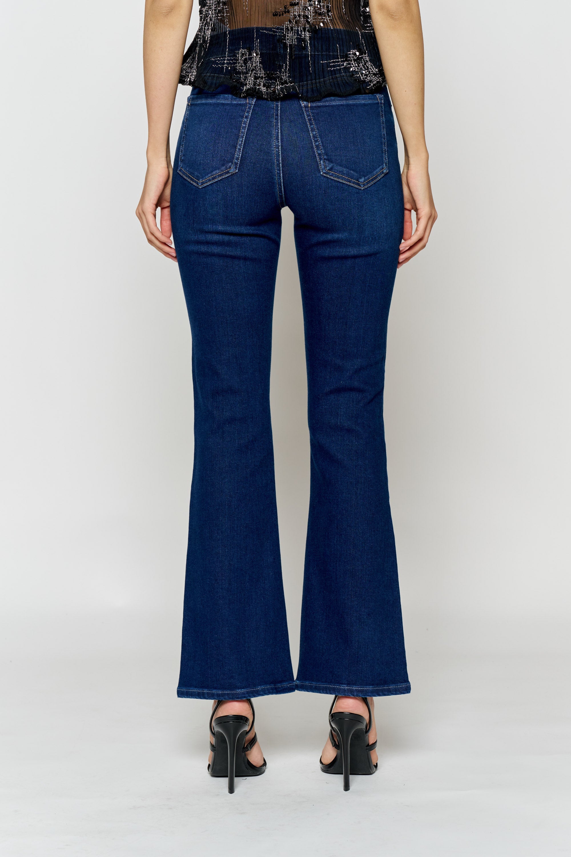 Women's bootcut jeans in dark blue, perfect for pairing with boots