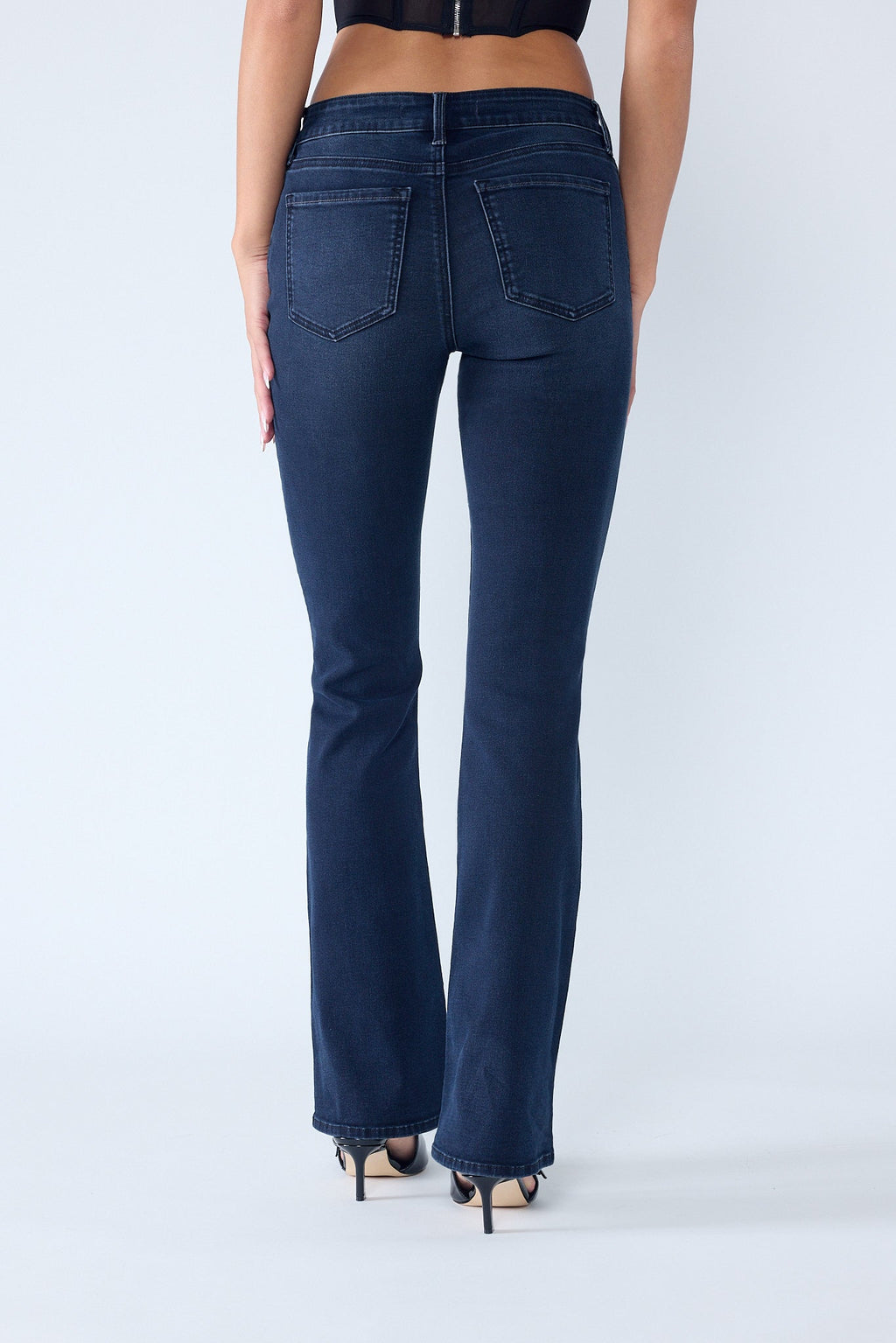 Women's bootcut jeans in dark denim, perfect for pairing with boots