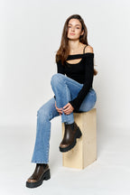 Women's blue bootcut jeans boots with a fitted black top