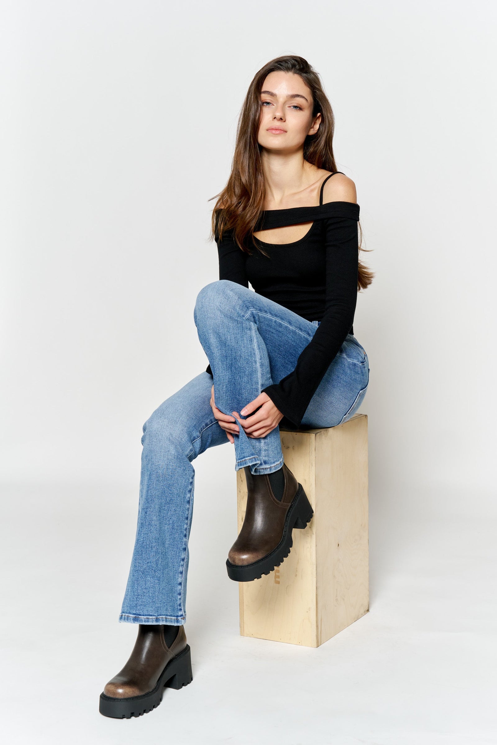 Women's blue bootcut jeans boots with a fitted black top