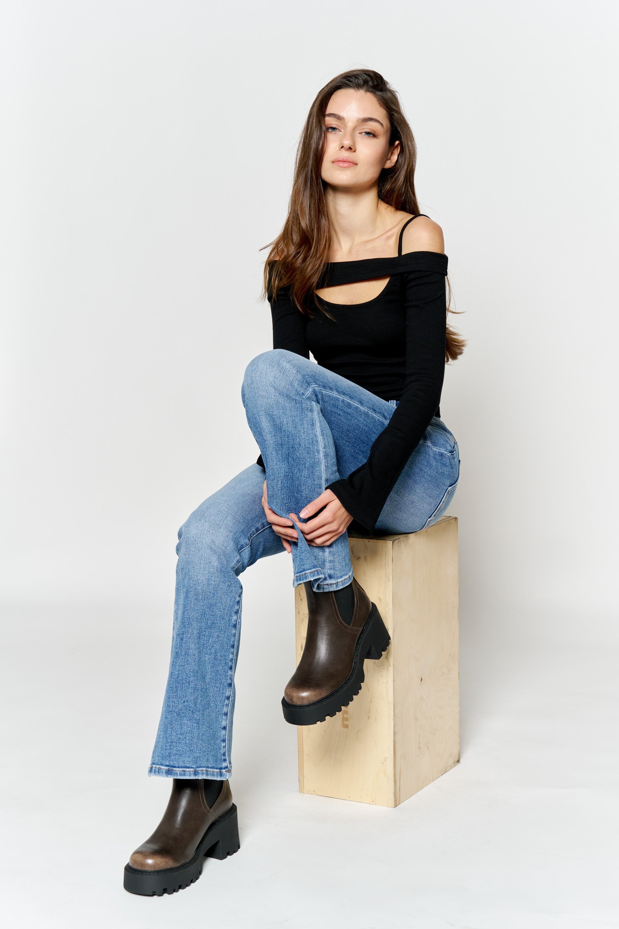 Women's blue bootcut jeans boots with a fitted black top