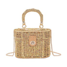 Braided cotton top handle bag in natural tones with a stylish clasp and detachable shoulder strap