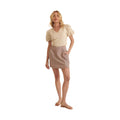 Woman wearing chic pinstripe skirt for women paired with beige puff sleeve top and sandals