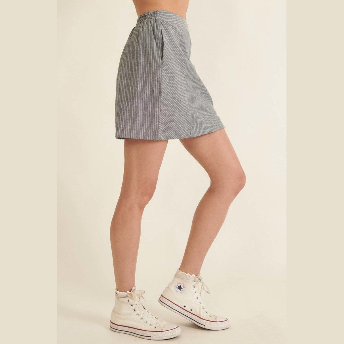 Chic pinstripe skirt for women from VacationGrabs paired with white high-top sneakers