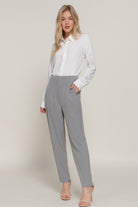 VacationGrabs women's stylish high rise trousers in gray paired with a white blouse and heels